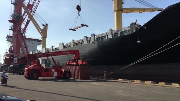 Shipped.com - Heavy duty forklift moving a fully loaded shipping container